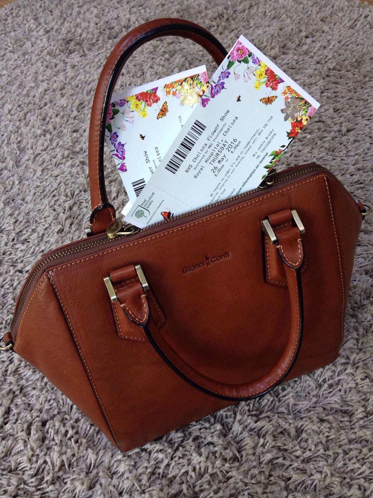 "Tickets and Gianni Conti bag at the ready"